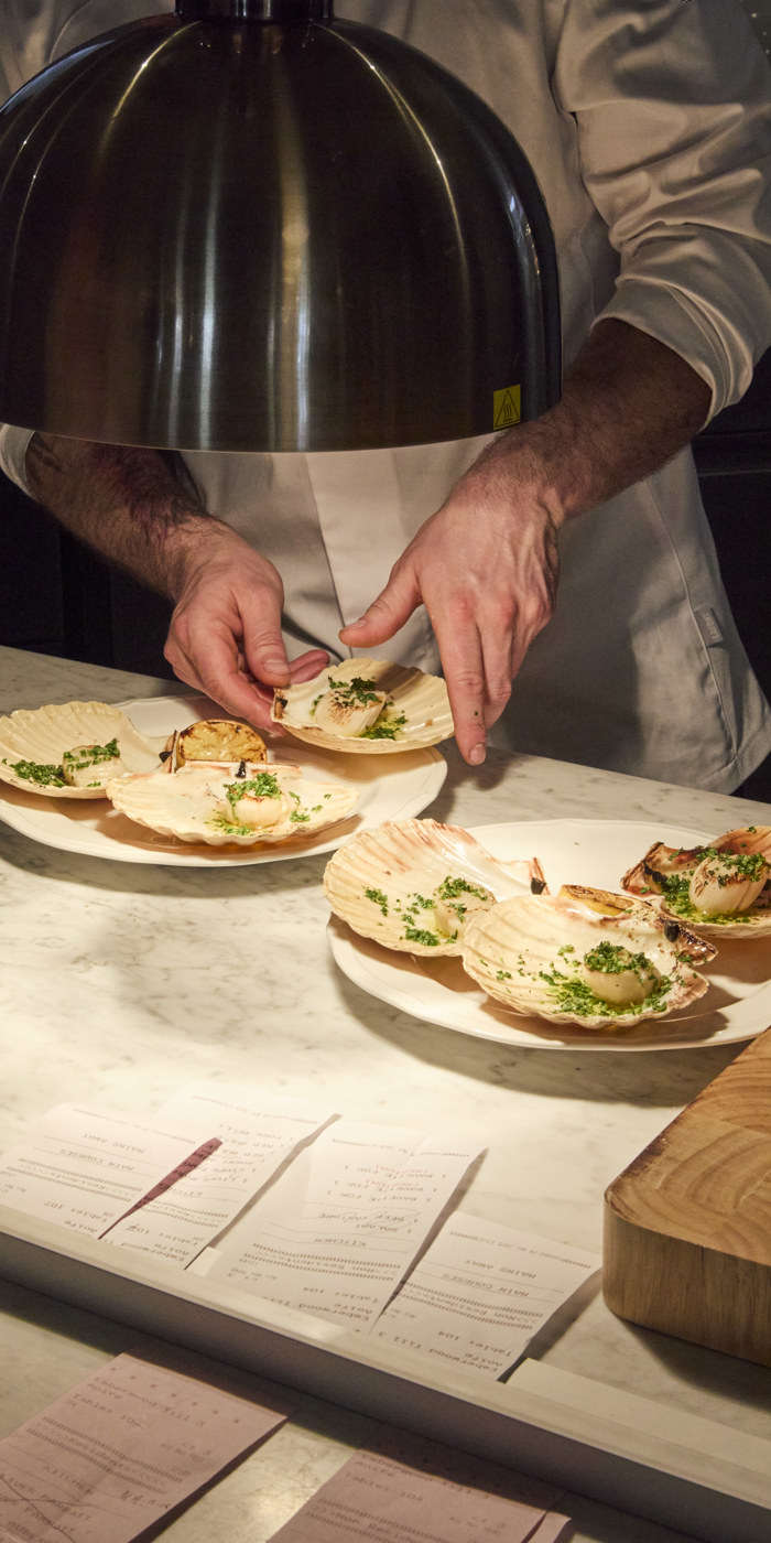 Chef on the pass with scallops